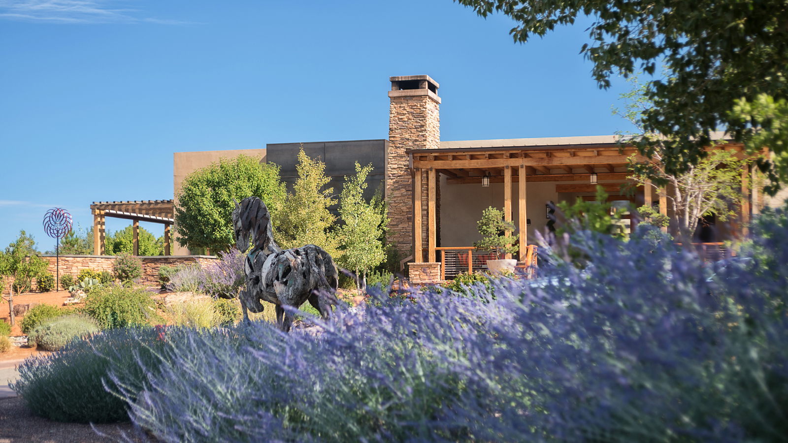 Un complejo de adobe bañado por el sol del Four Seasons Resort Rancho Encantado Santa Fe, enclavado en el paisaje desértico de altura.
