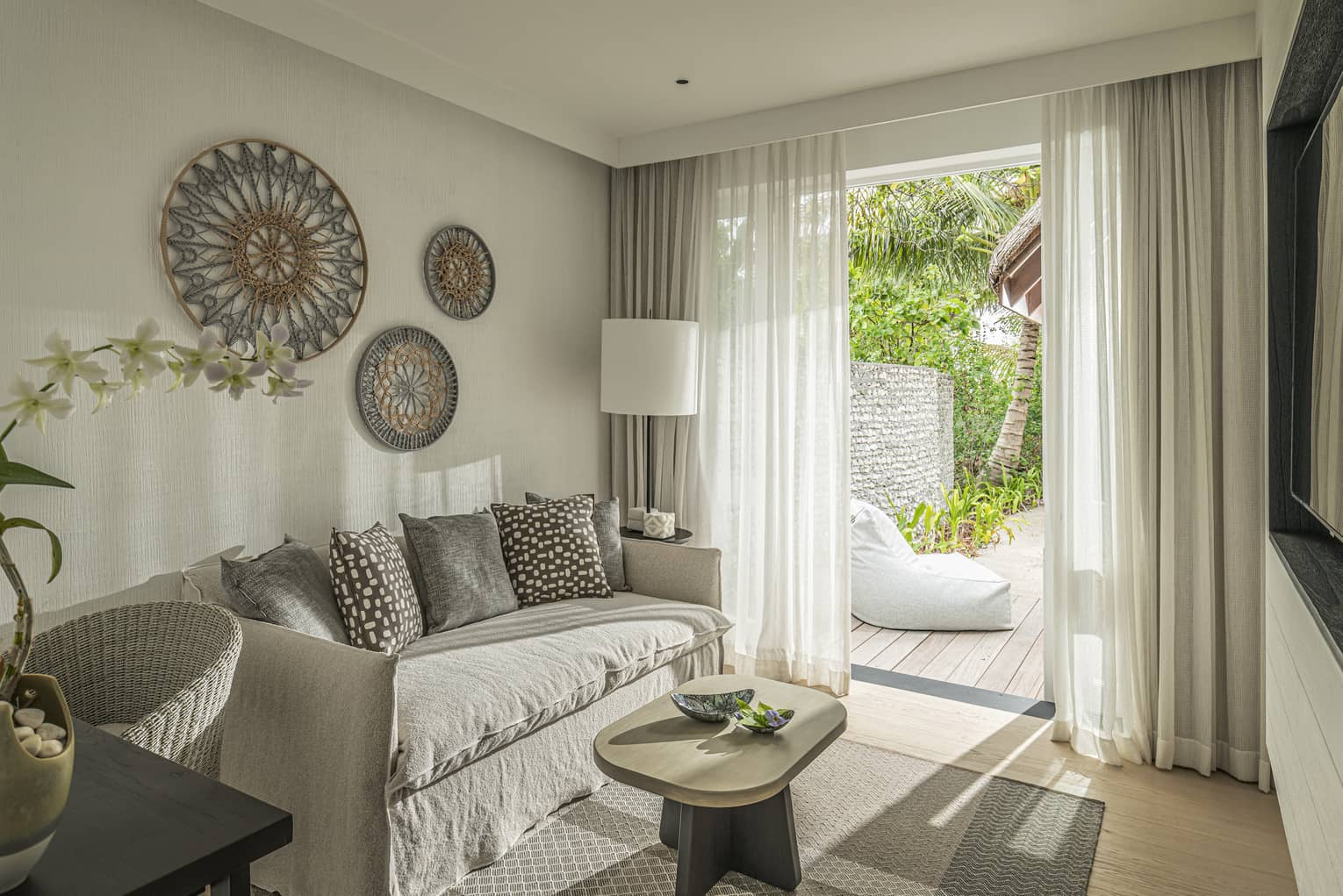 Bedroom with sofa, desk and walk-out deck with lounge chair