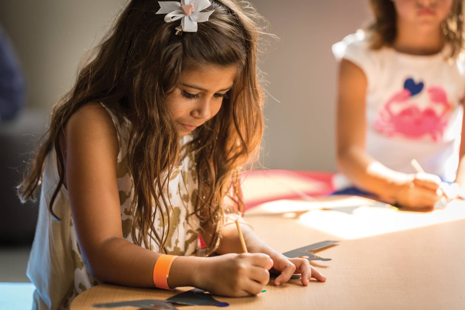 Young girl colours picture in Kids Centre