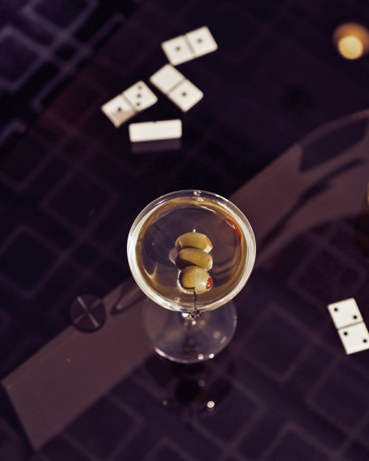 A martini on a black table.