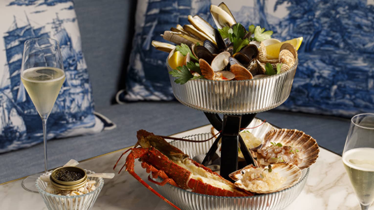 Seafood tower with mixed shellfish on marble table with caviar and champagne