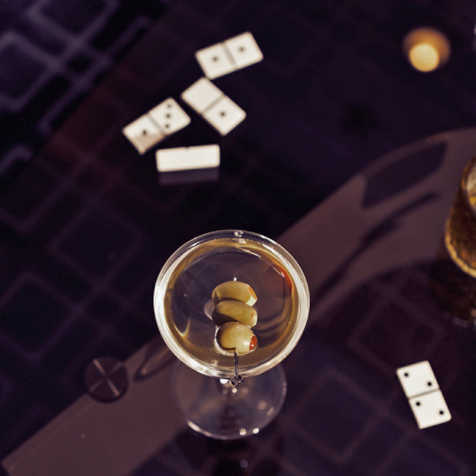 A martini on a black table.