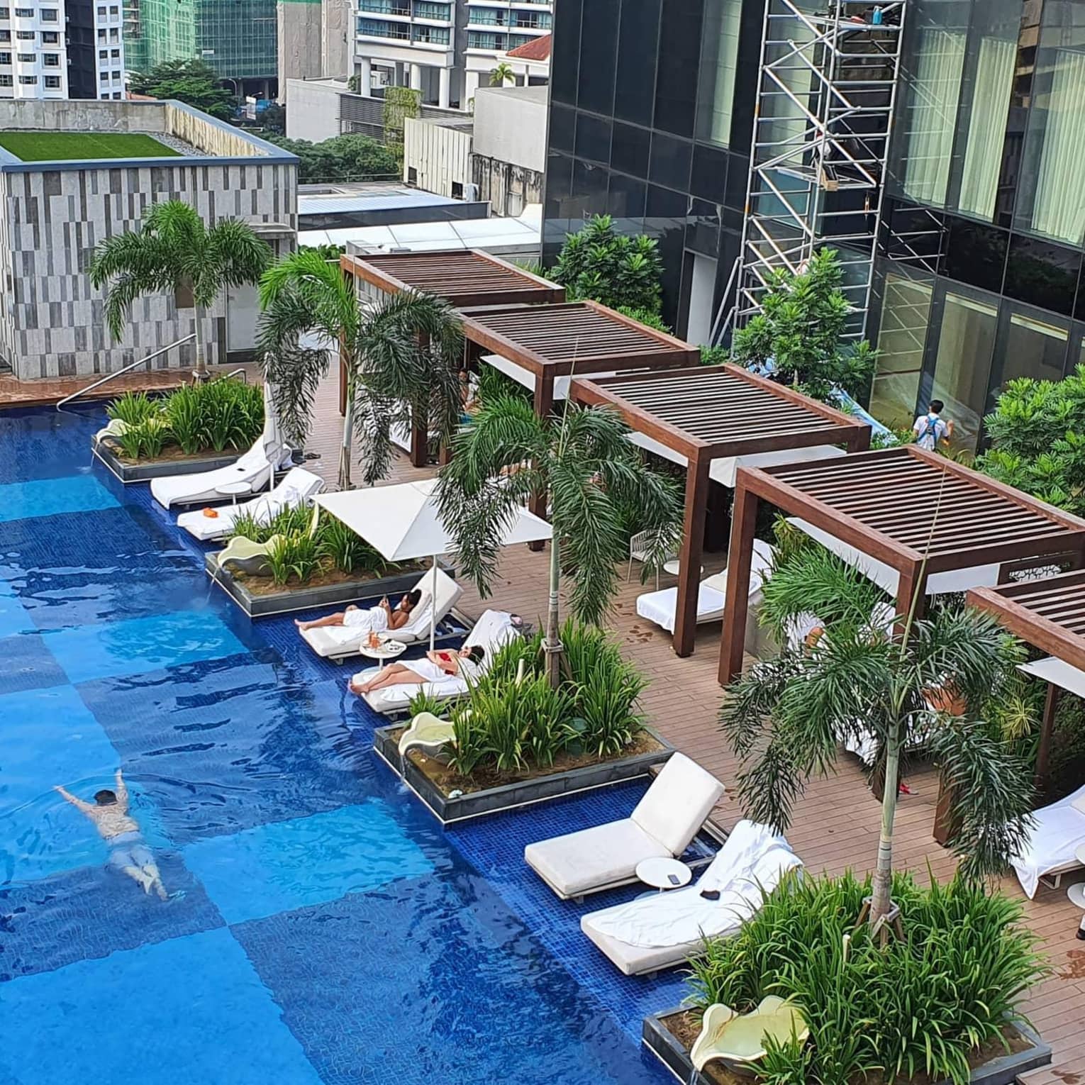 An aerial view of the pool, lounge chairs and cabanas