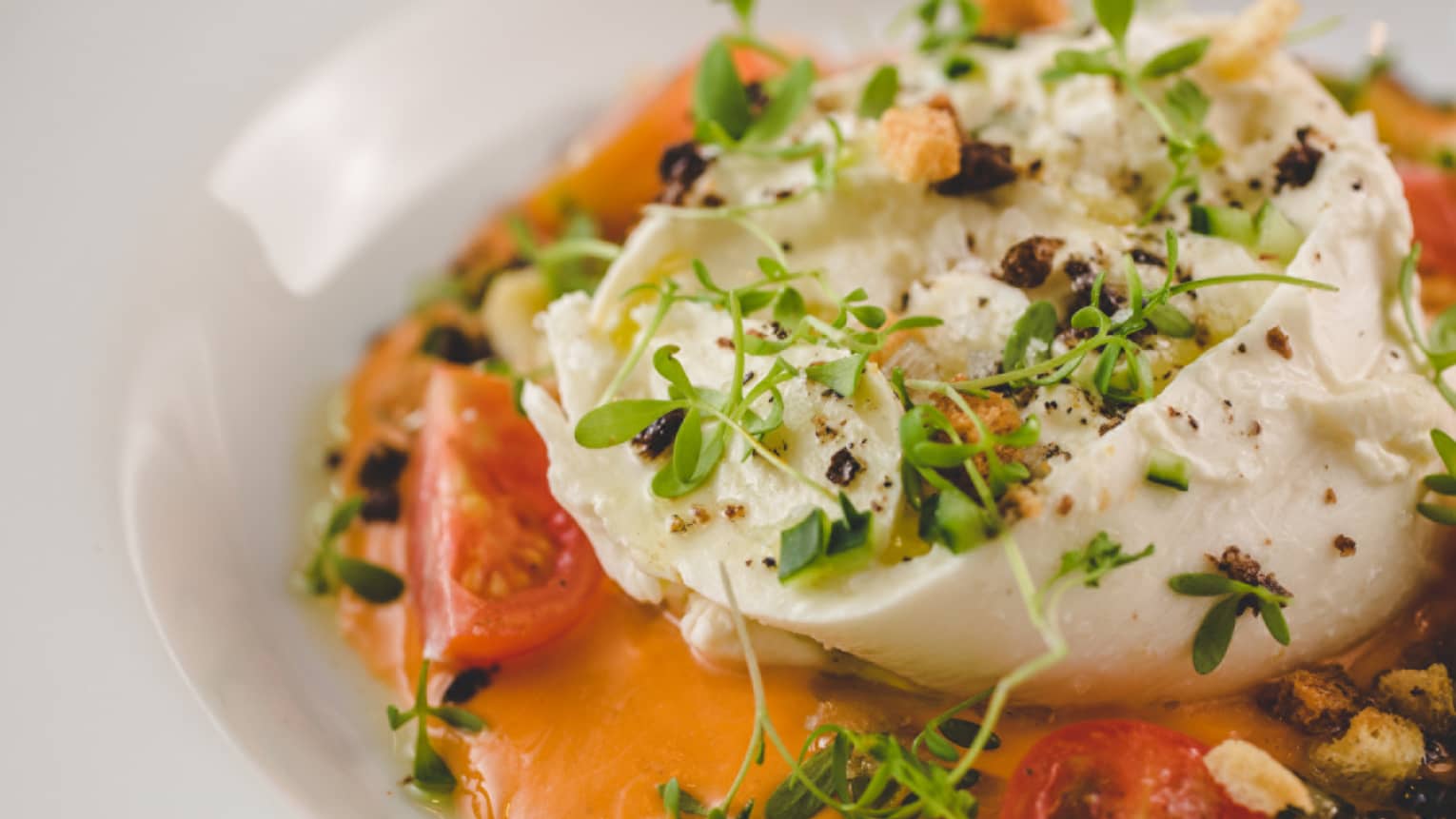 A cheesy dish with a tomato base sauce.
