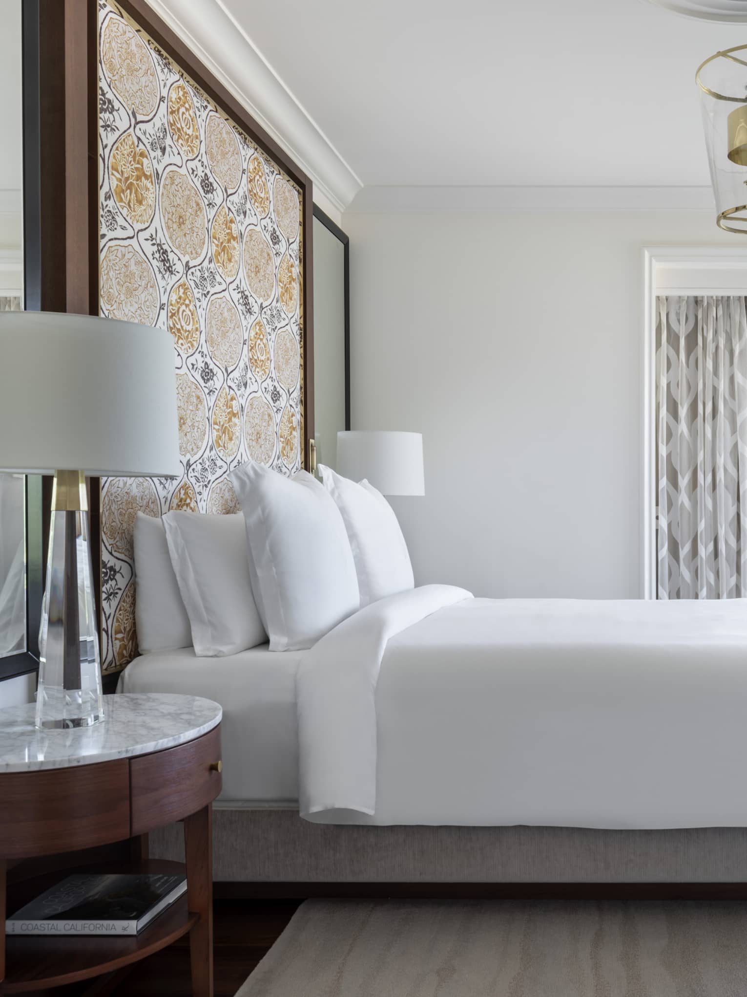 The bed and loveseat of a Malibu Corner One-Bedroom Suite.