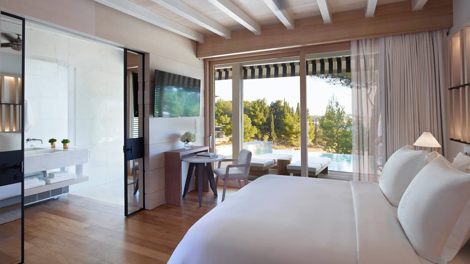Bungalow  Sea View with Pool, white King bed, mirrored doors to bathroom, floor-to-ceiling window overlooking pool, desk and chair