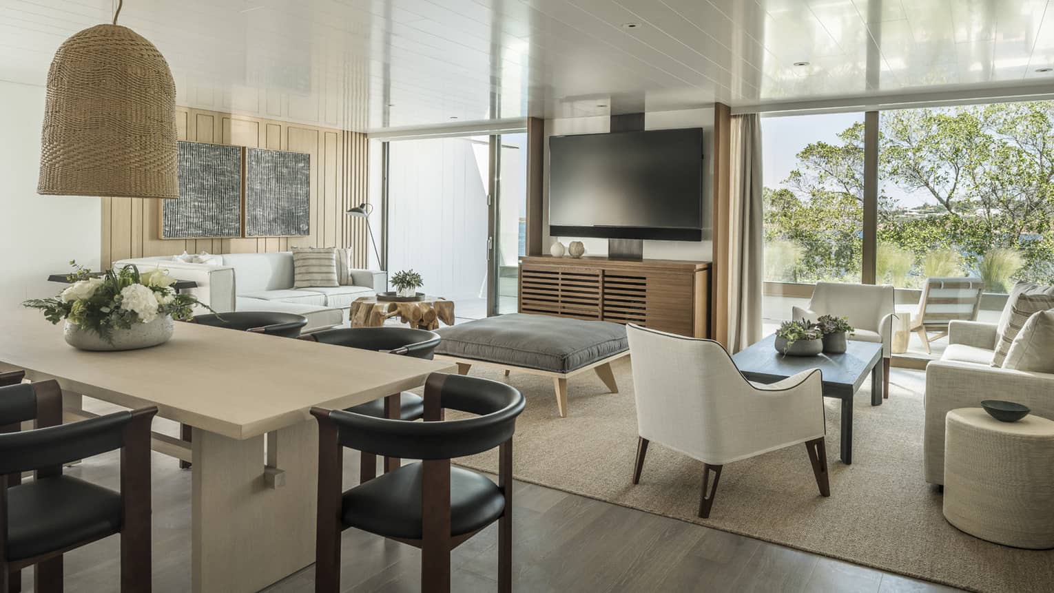 Nafsika One Bedroom Terrace Suite with Pool living room with white sofa, arm chair, ottoman, high table with leather stools, flat screen TV