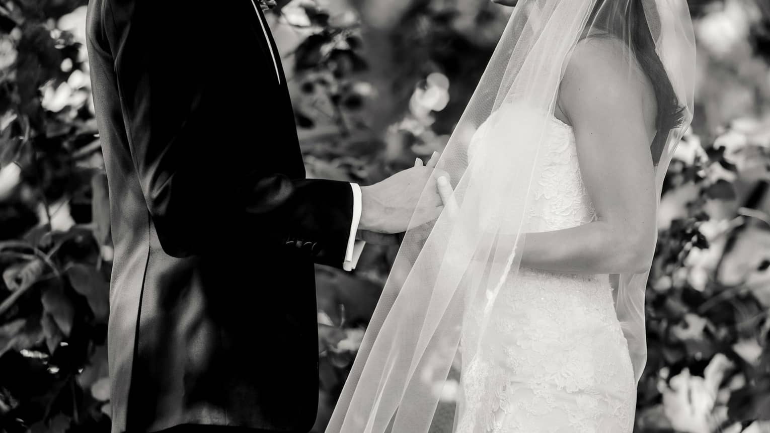 Black and white photo of bride and groom during wedding ceremony