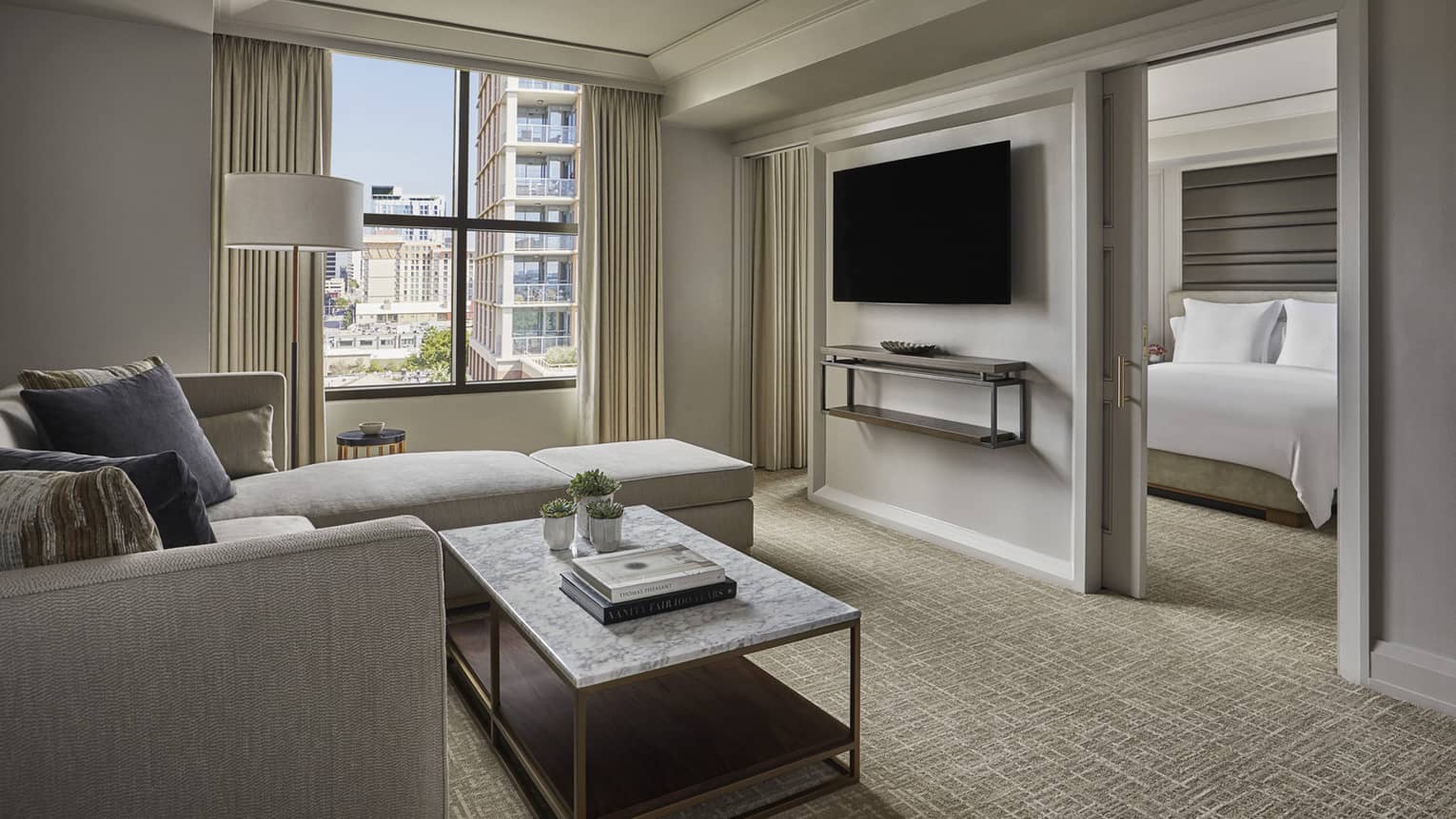 City View Executive Suite living room, window, TV on wall dividing bedroom
