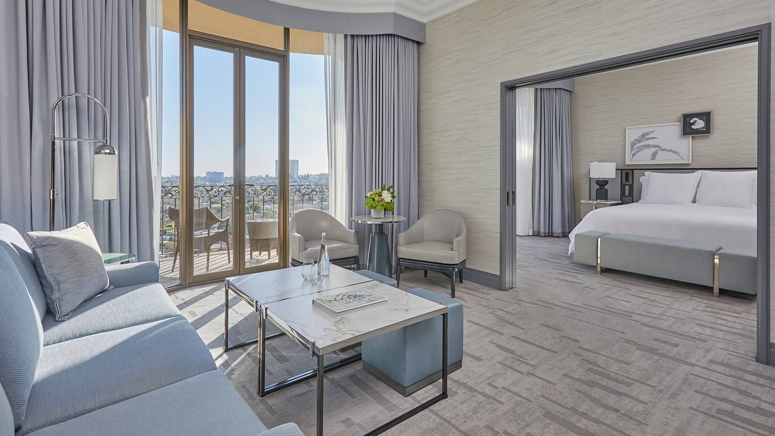 Hotel suite living room with balcony and separate bedroom
