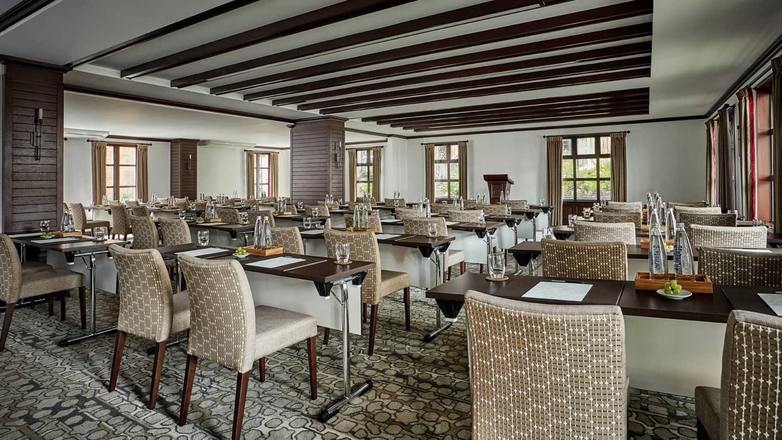 Rows of meeting tables and plush chairs in Casa Medina Ballroom