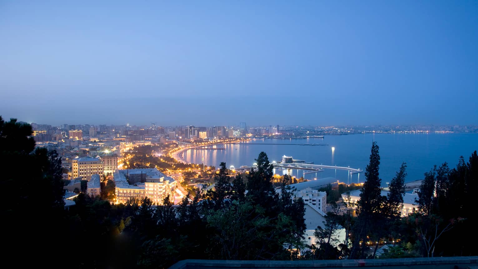 Aerial view of lights of Baku The Old City at night around Caspian Sea coastline