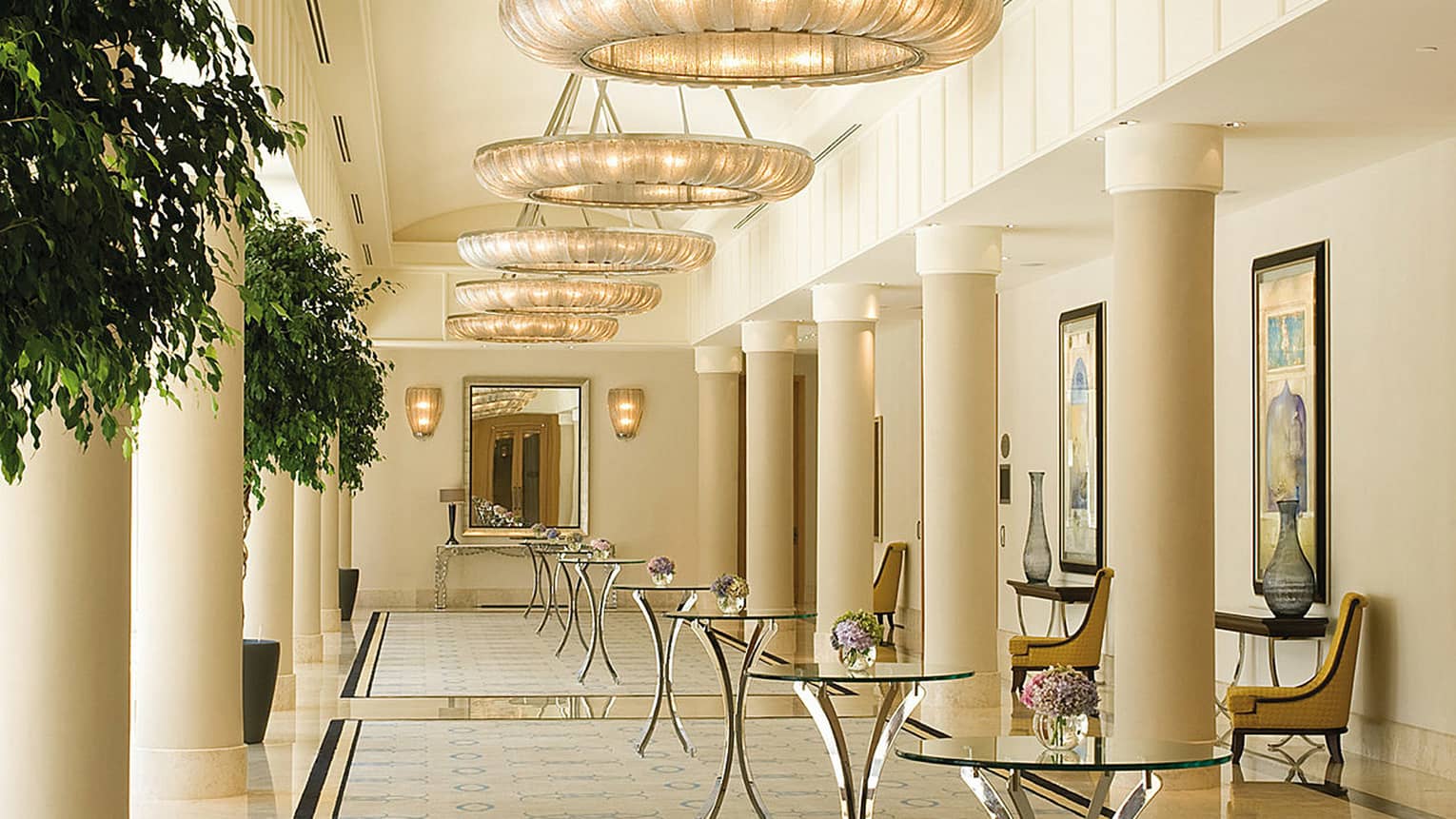 White pillars, glass cocktail tables in bright Atik Pasha ballroom pre-function area 