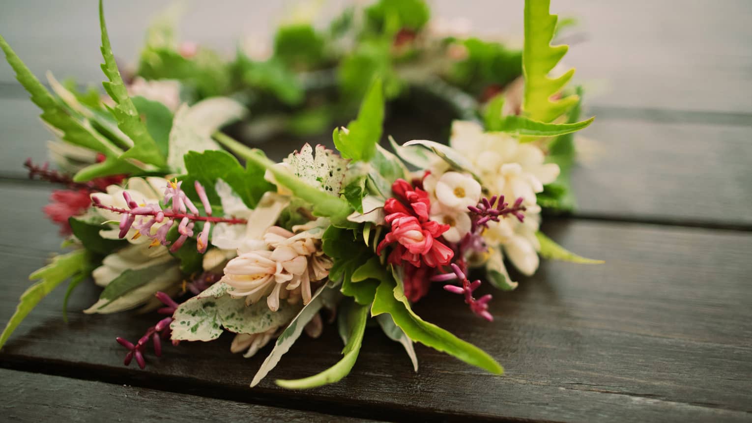 Tropical flowers arranged in floral wedding crown on table
