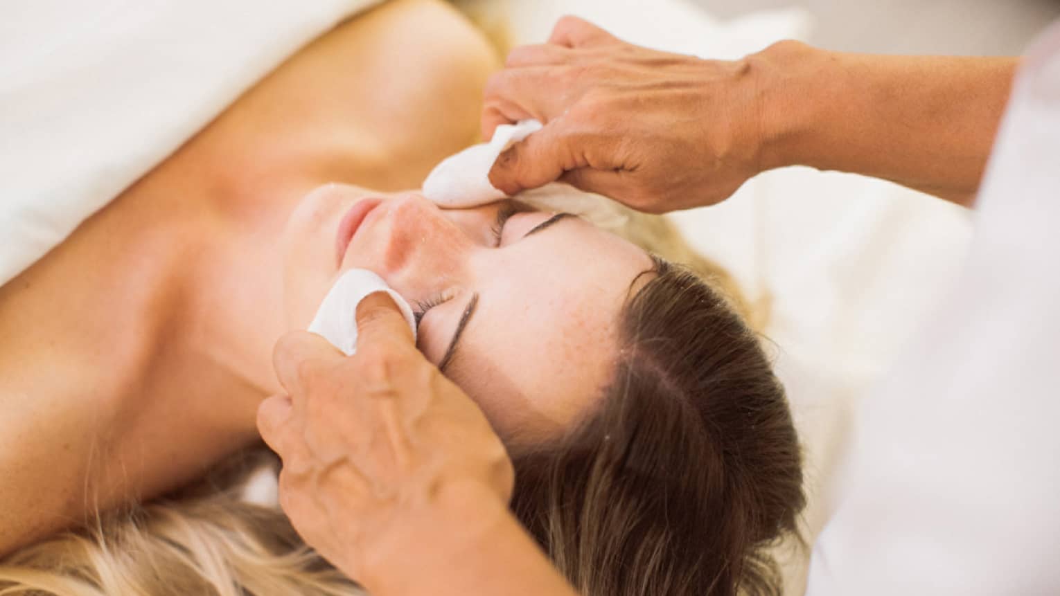 A woman receiving a facial. 