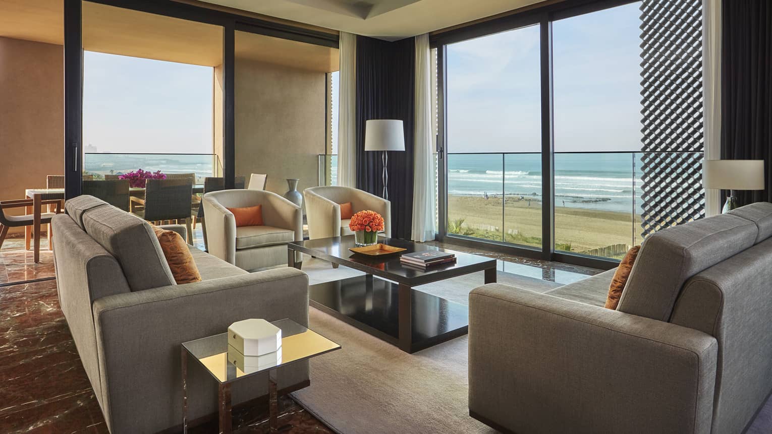 Imperial Suite Ocean View living room sofas, armchairs, corner windows with view of beach, Atlantic