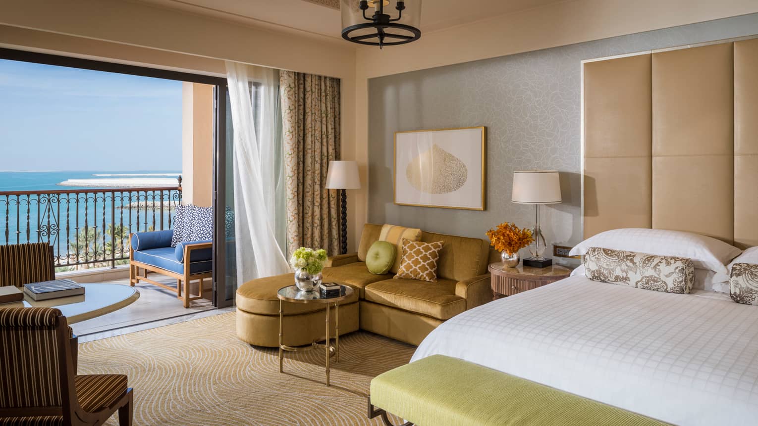 Premier Sea-View Room with L-shaped gold sofa beside oversized sliding glass door to balcony