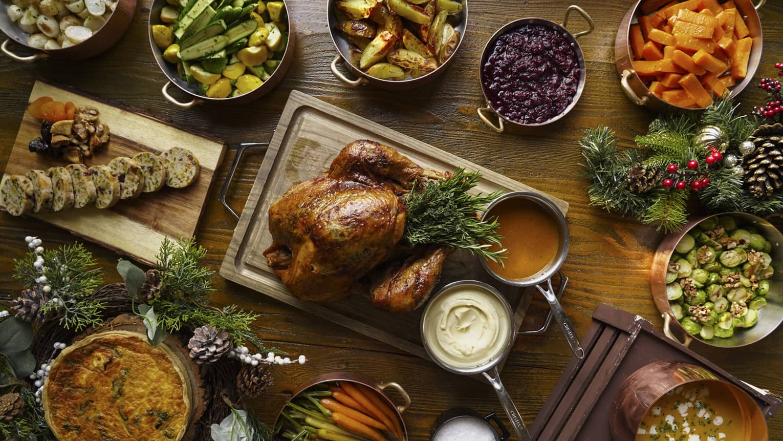 A full festive feast with a Turkey in the centre, and several copper pots of stewed vegetables surrounding