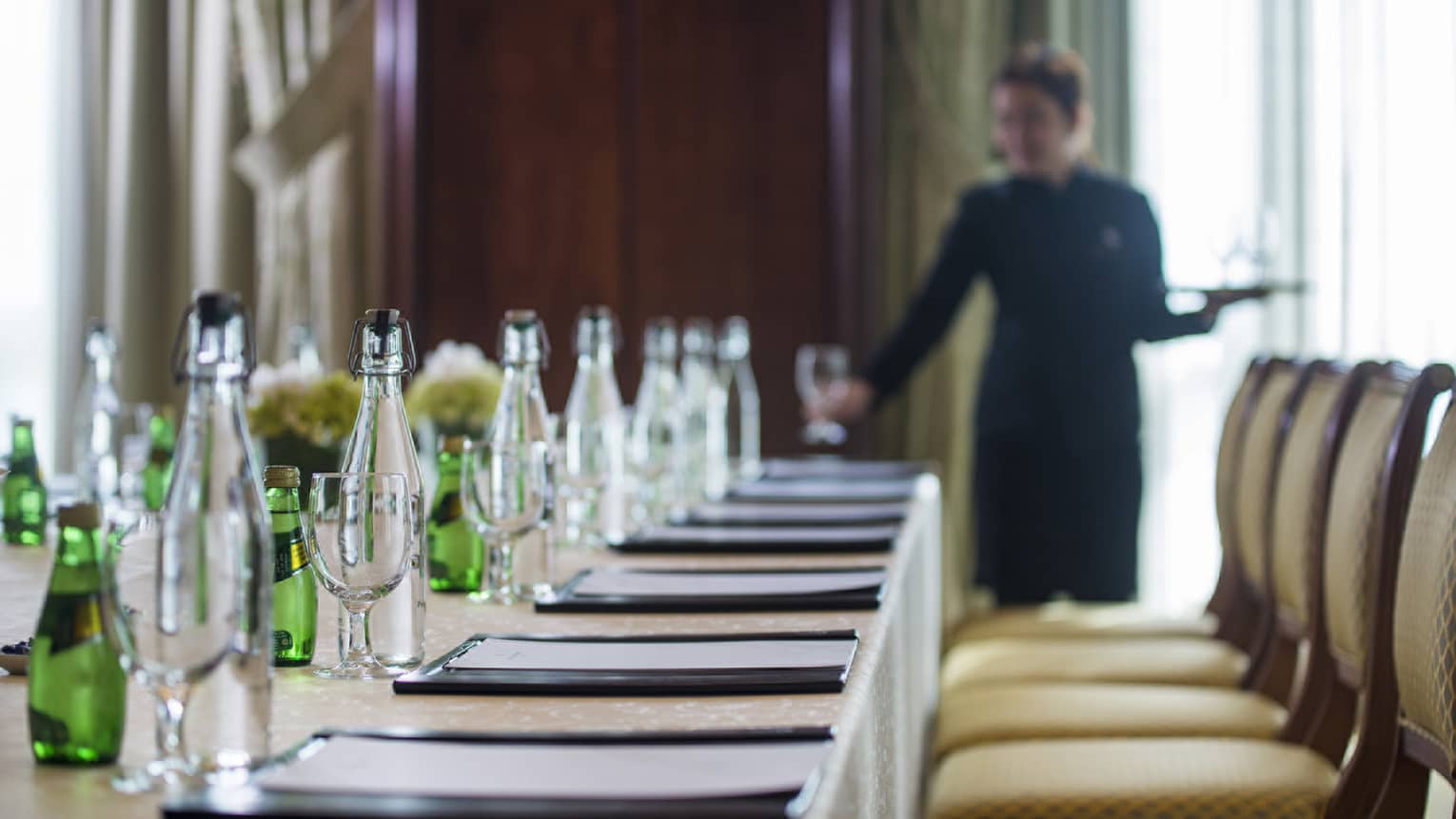 Jnan Meeting Room with staff member arranging table setting