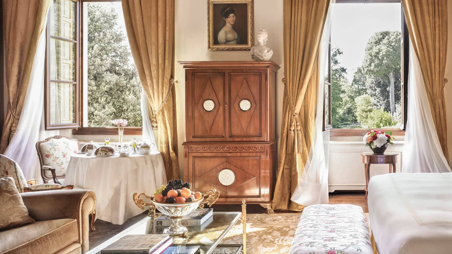 Renaissance Suite seating area, wood dresser, bright windows under dome ceiling, mural