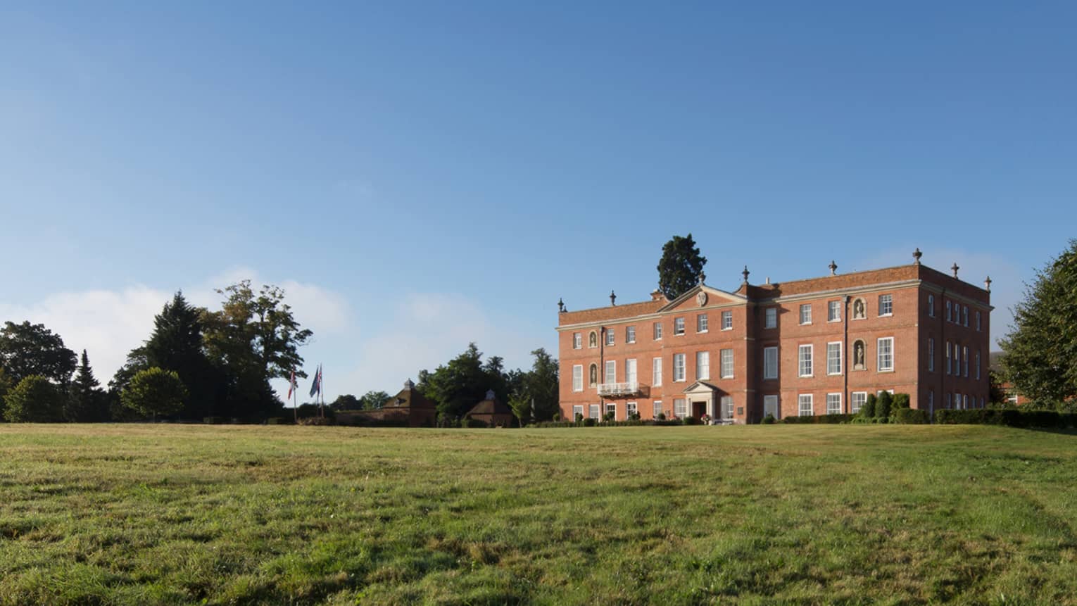 Four Seasons Hotel Hampshire red brick building exterior in rolling green countryside