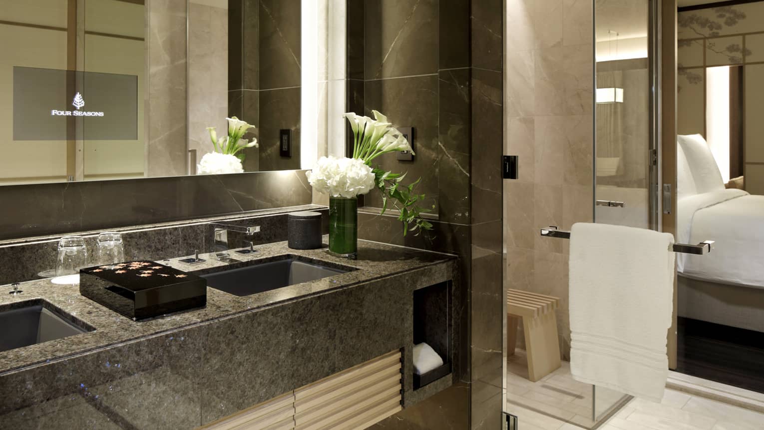 Bathroom with two sinks and glass shower