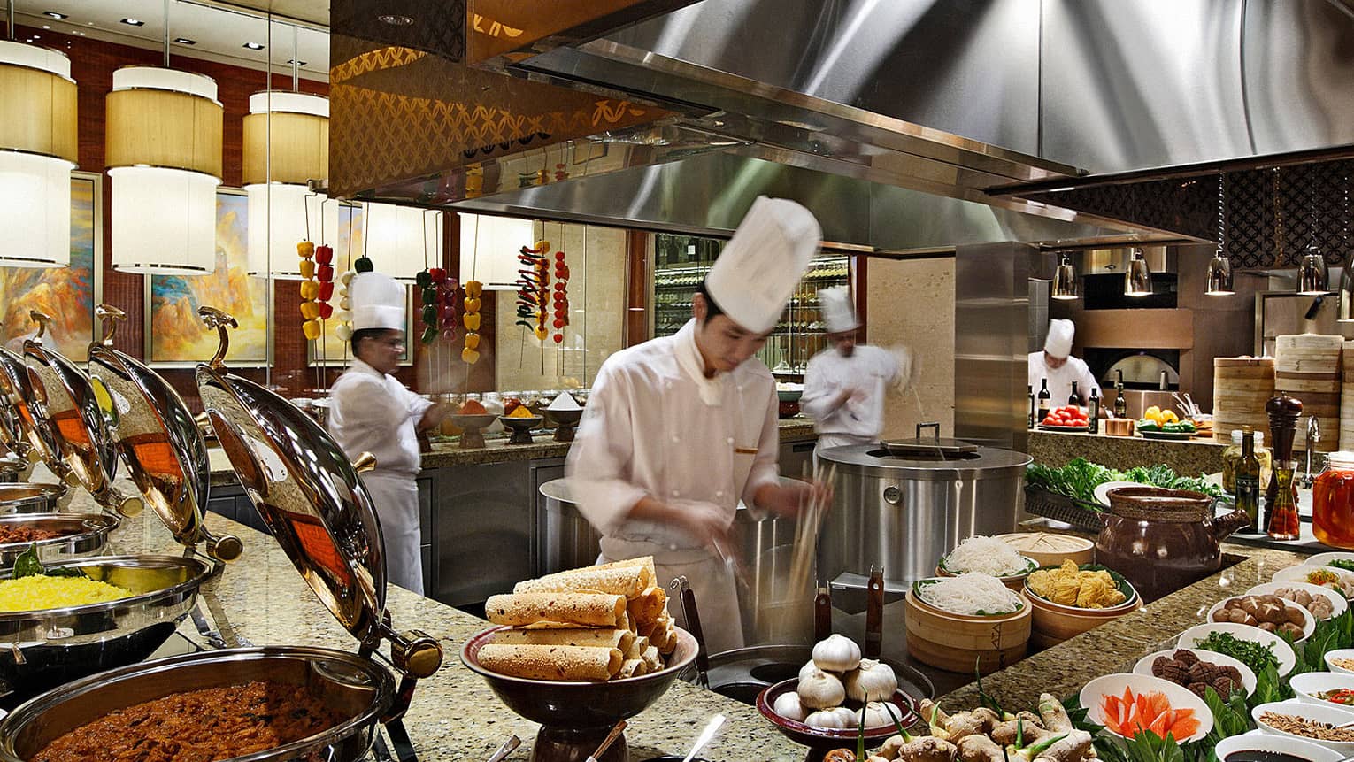 Multiple Four Season Chefs cooking in an industrial kitchen