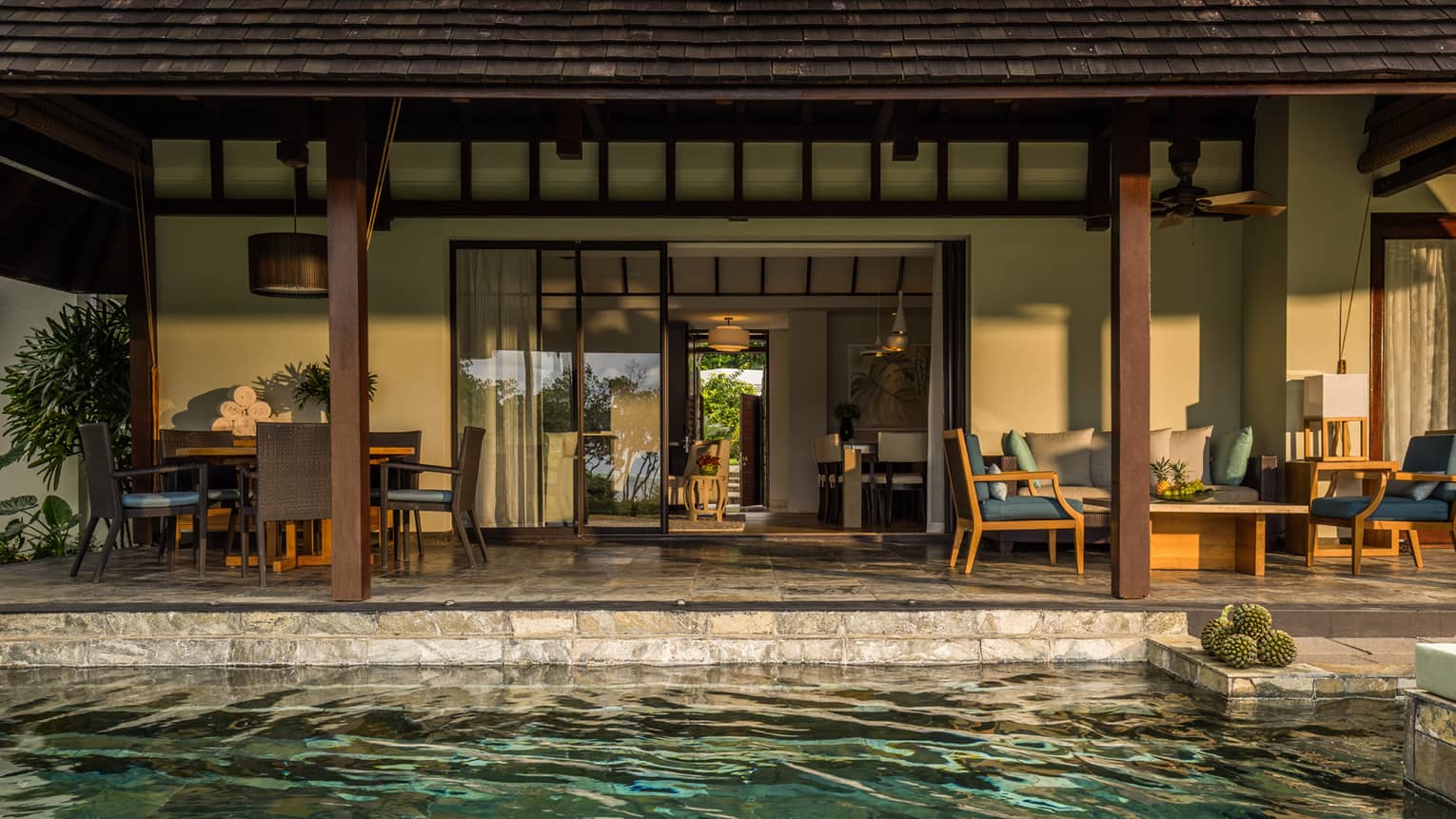 Garden Residence Villa plunge pool in front of stone patio dining table, seating area