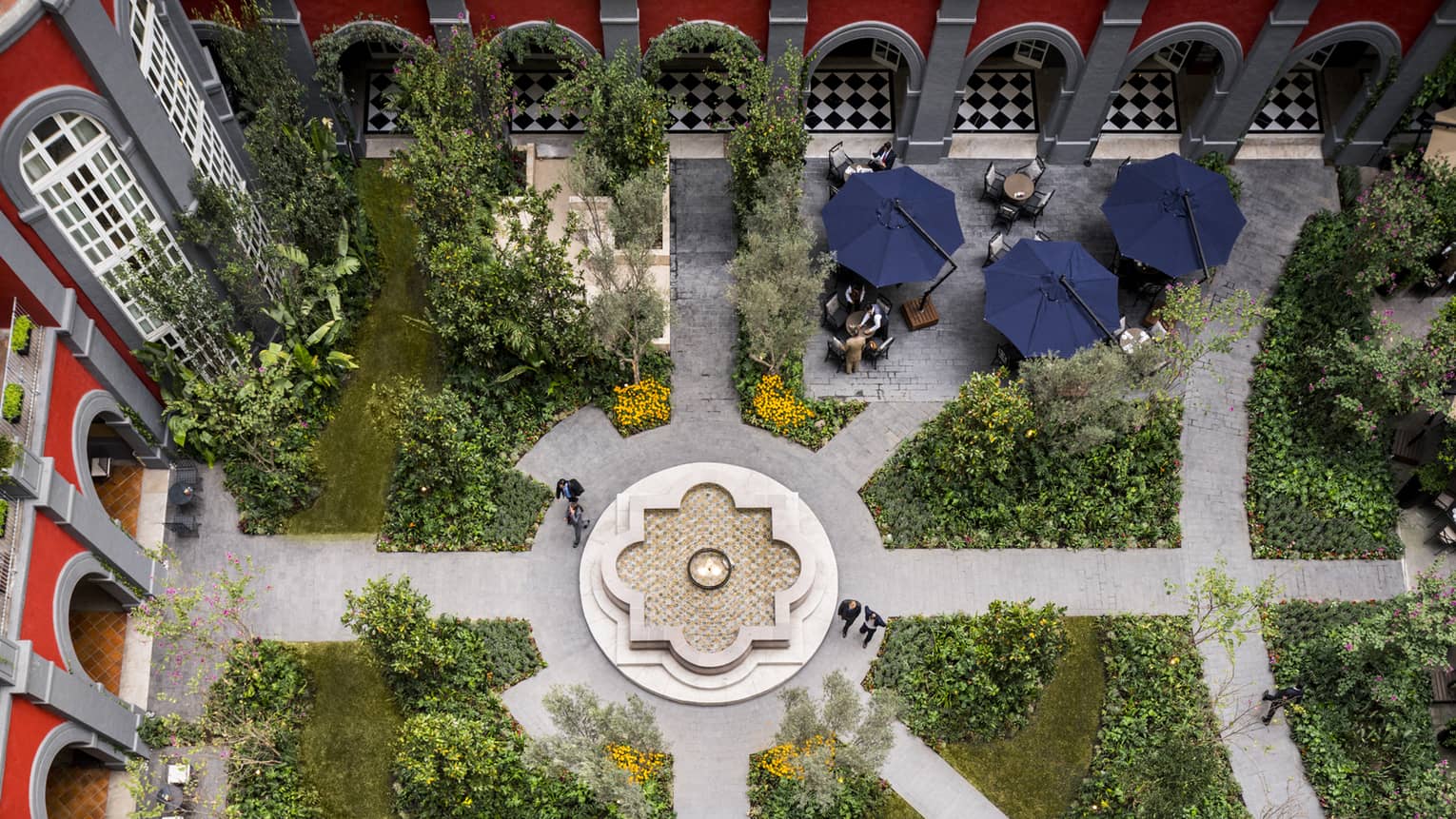 Aerial view of hotel courtyard patio, gardens and flower-shaped fountain