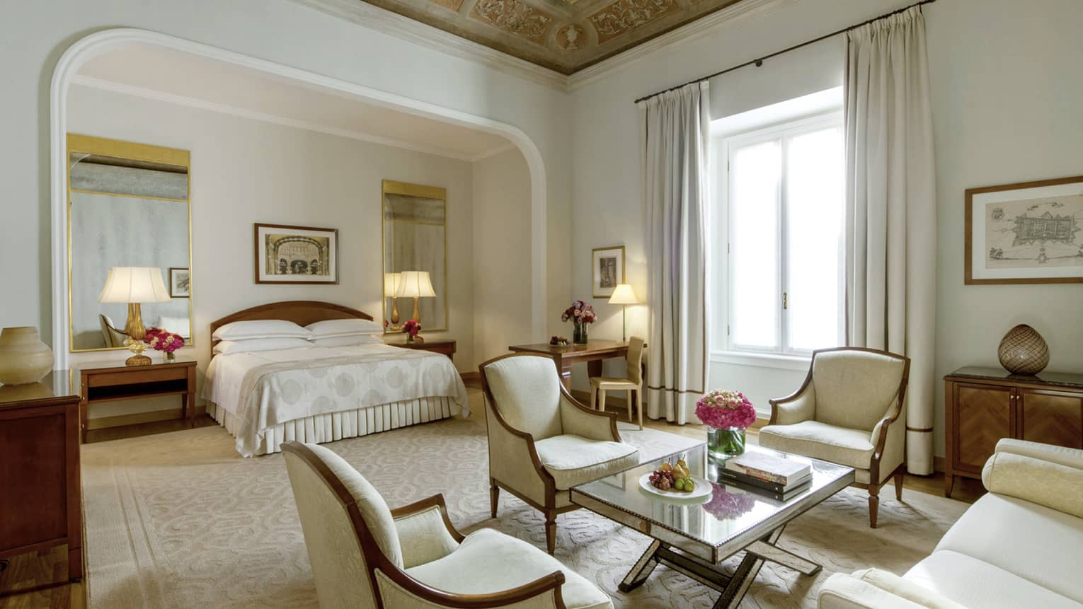Fresco Suite soaring ceilings, bed in alcove with mirrors, antique-style ivory armchairs around table