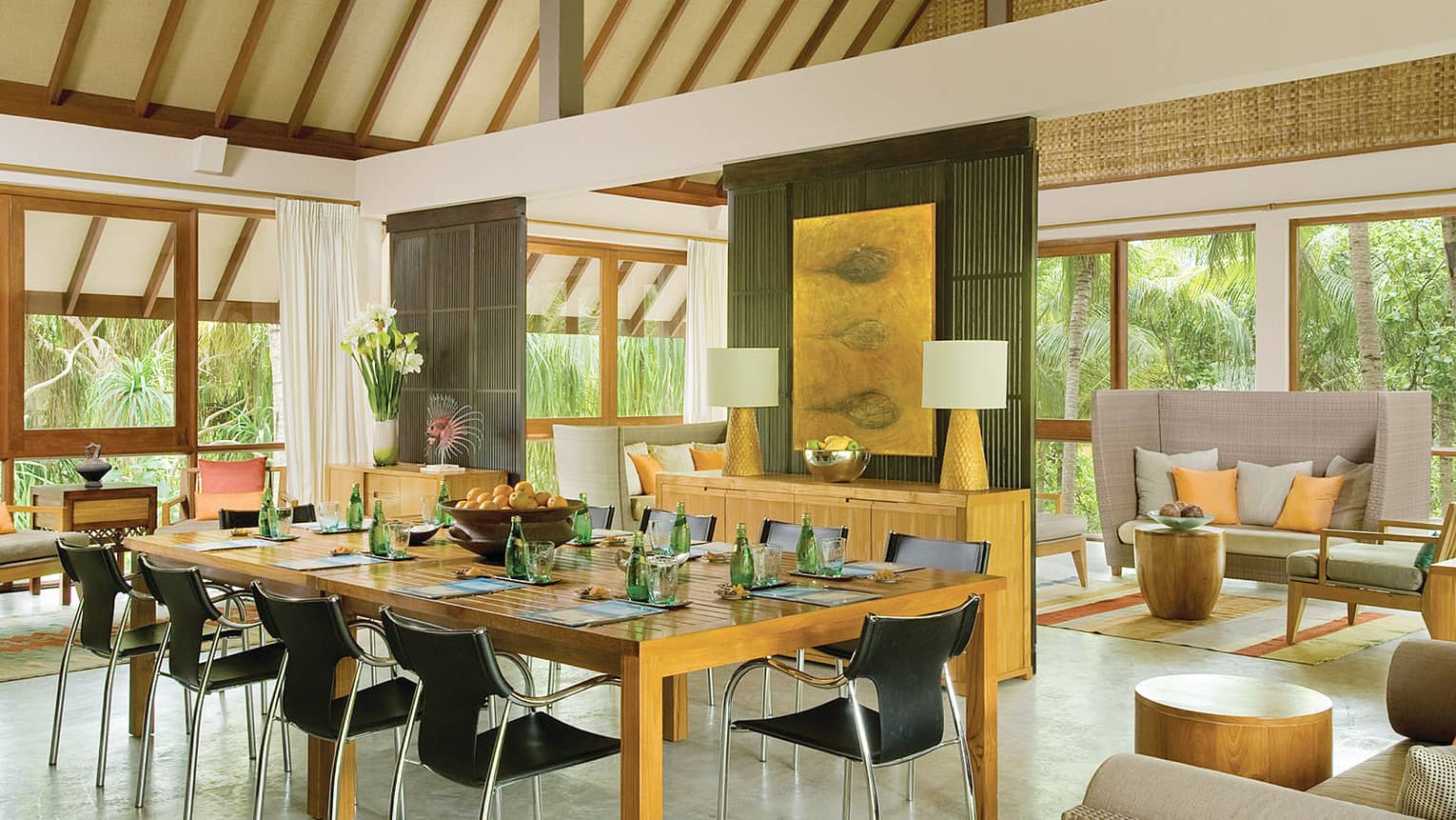 Comfortable light-filled meeting room with contemporary furnishings, surrounded by palm trees