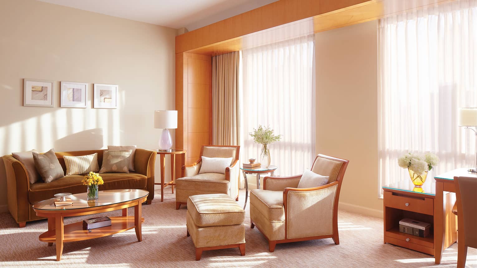 Executive Suite beige velvet armchairs, bronze sofa, table by large windows, sheer curtains