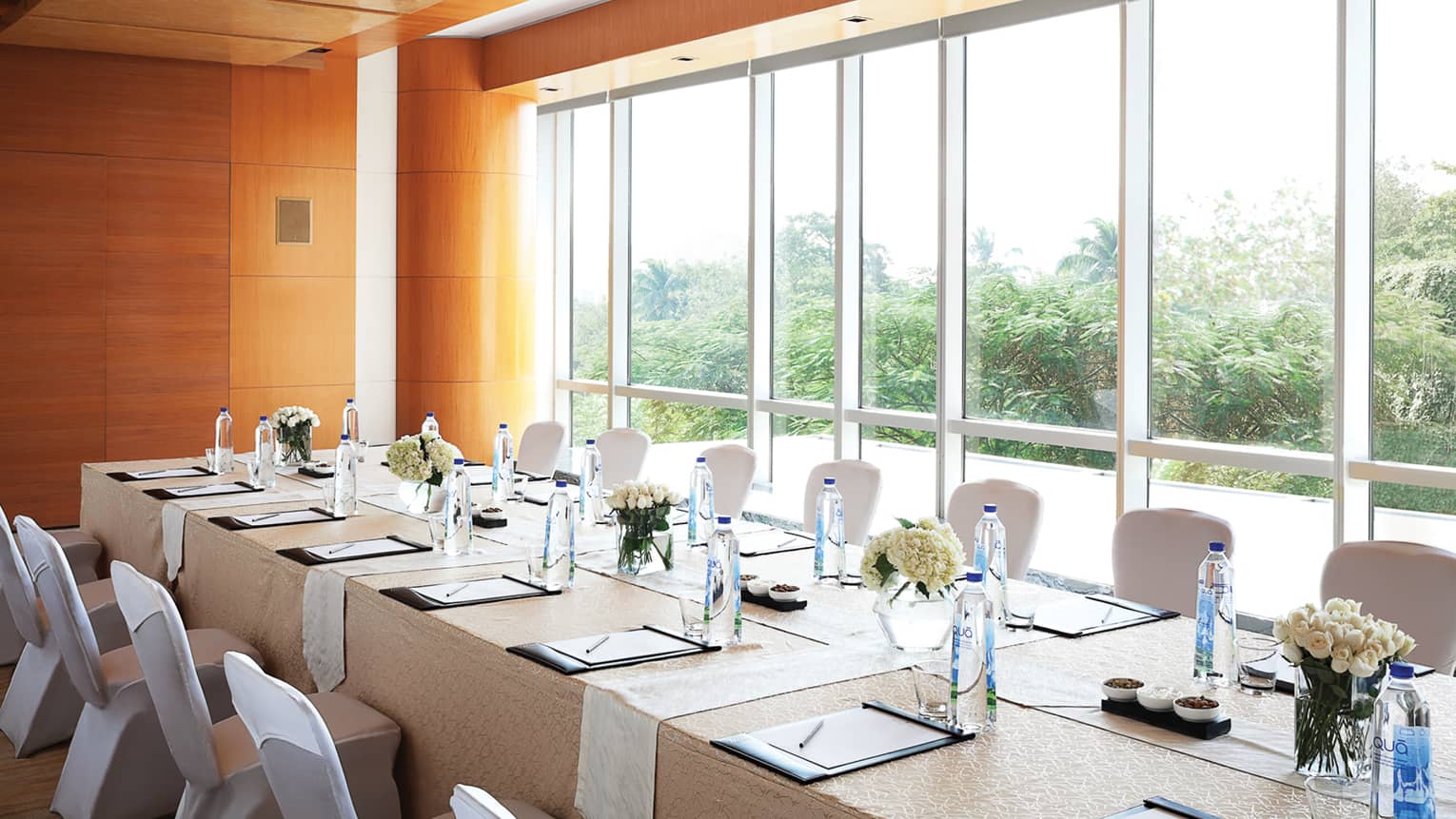 Basant Meeting Room, long private boardroom table by floor-to-ceiling sunny window