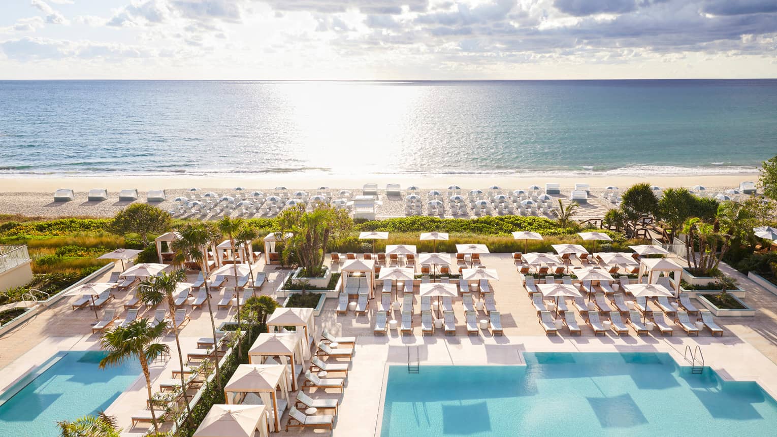 Aerial view of sprawling Four Seasons Resort Palm Beach pool, patio and beach by ocean