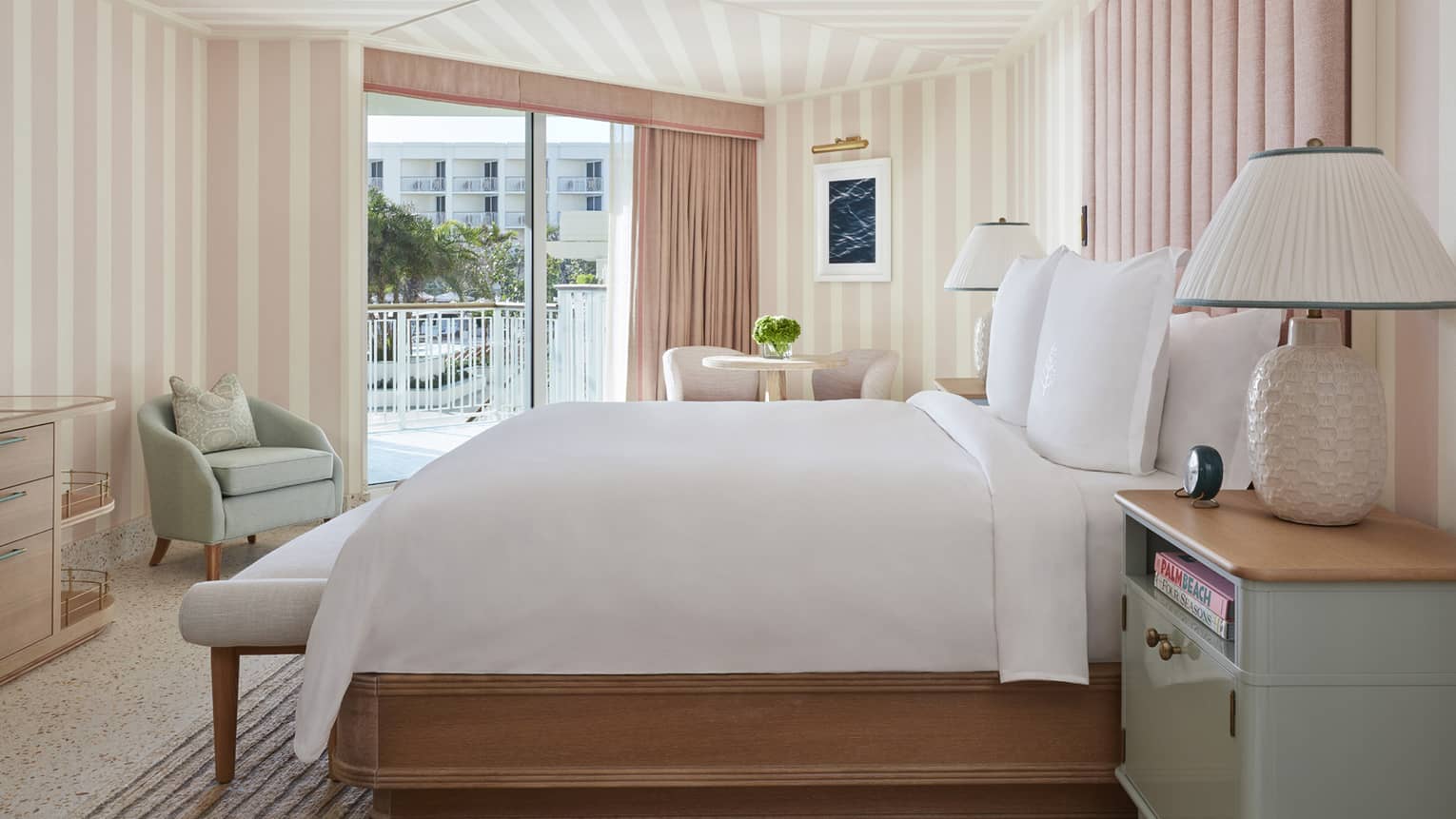 Ocean View Cabana Terrace Room hotel bed, lamp against pink and white walls