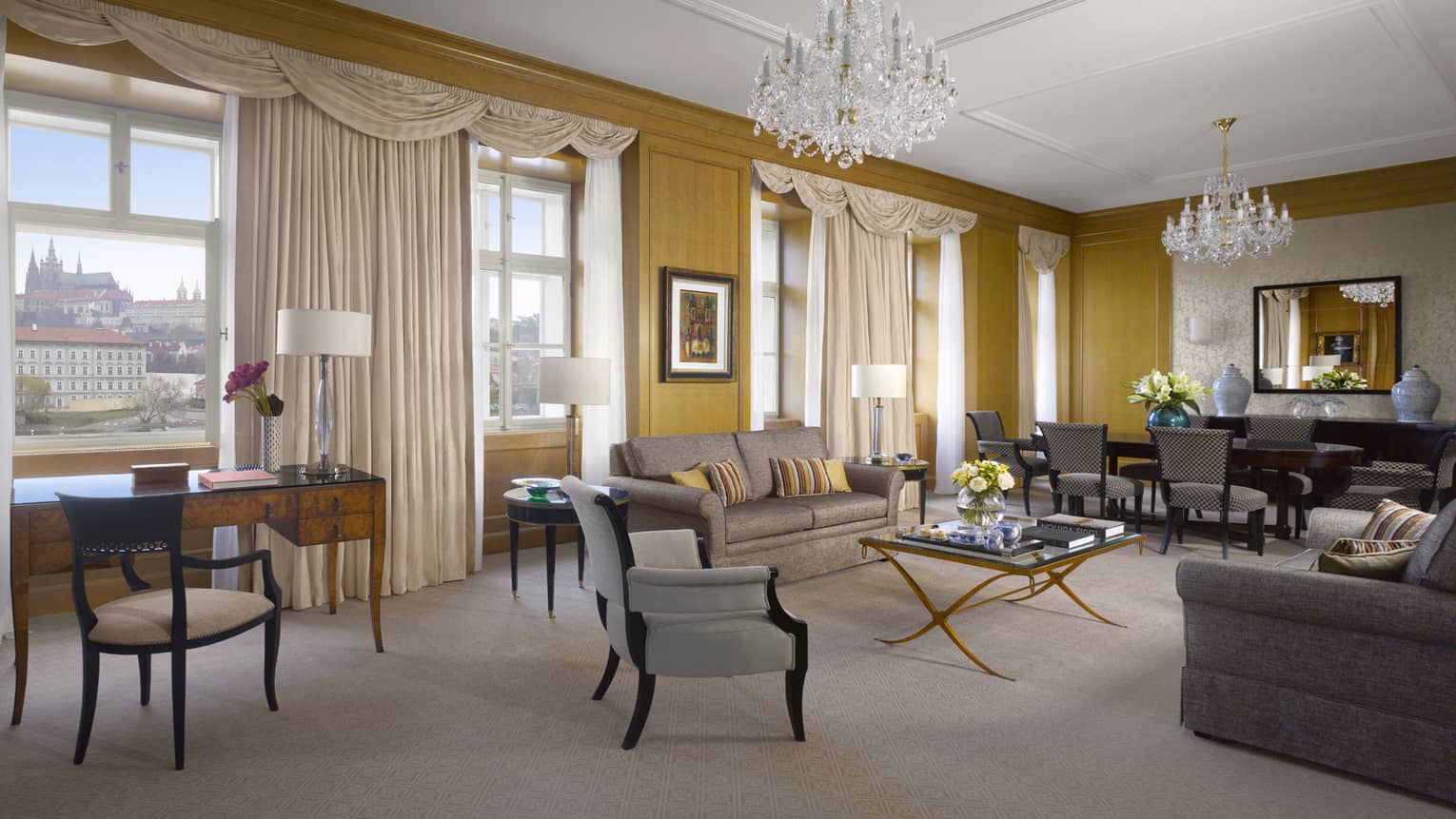 Premier Suite living room, desk, blue armchairs, sofa, glass coffee table with roses, tea service, dining table
