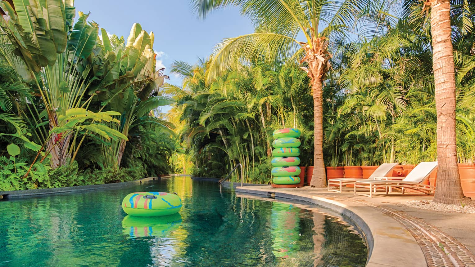 Inflatable pool toy in tropical outdoor swimming pool