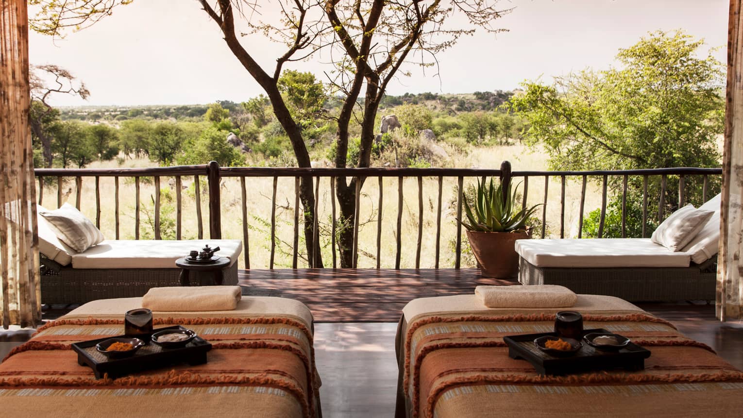 Spa couples massage beds with trays side-by-side in front of patio
