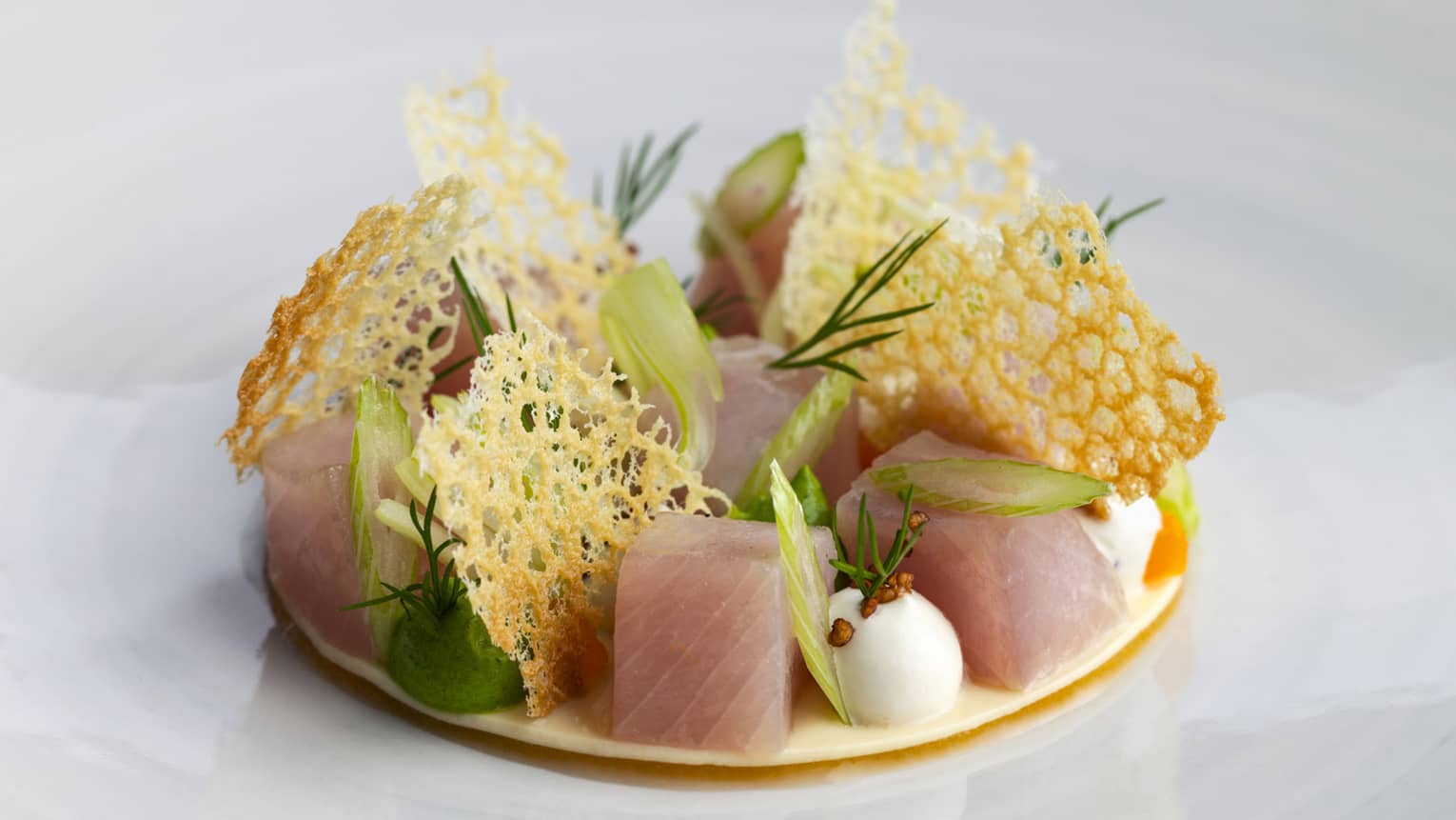 Sashimi cubes and garnishes on round plate