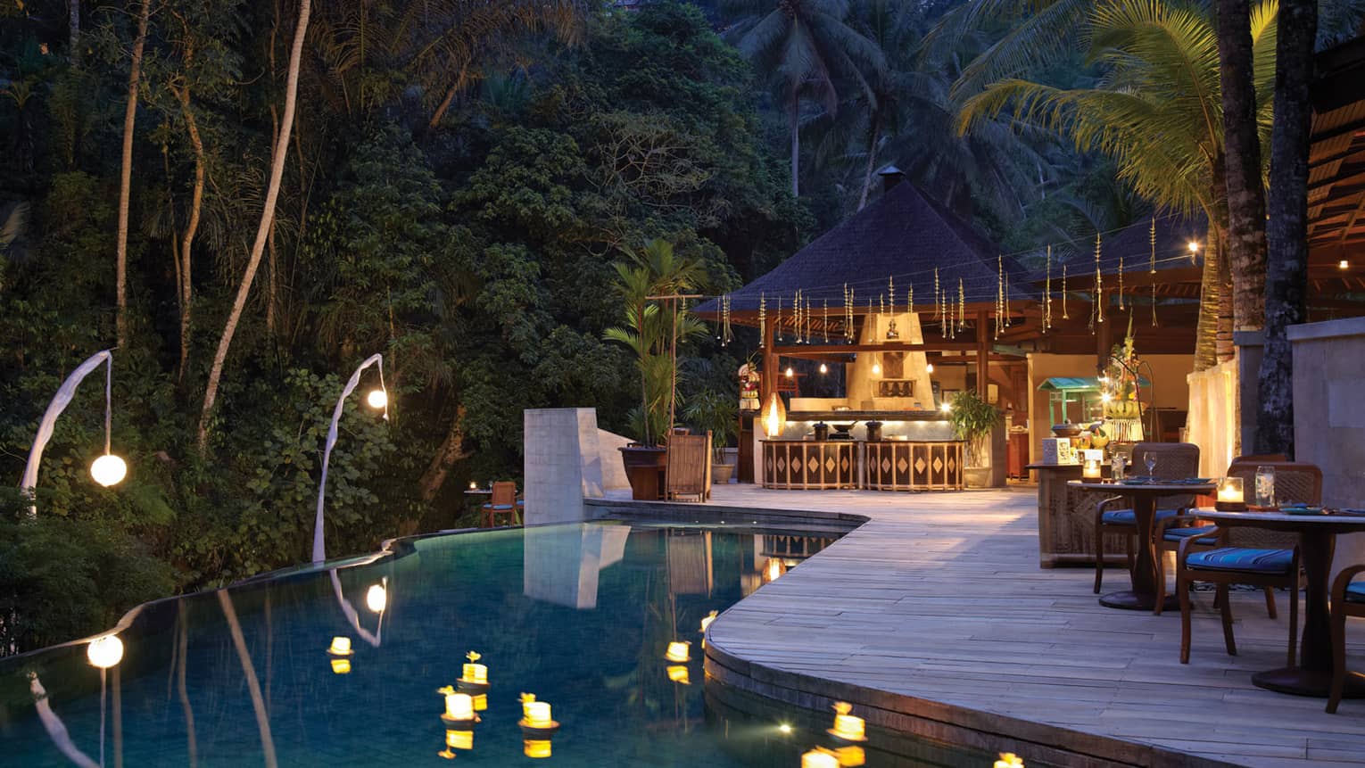 Wedding venue by pond with lanterns at luxury resort near forest