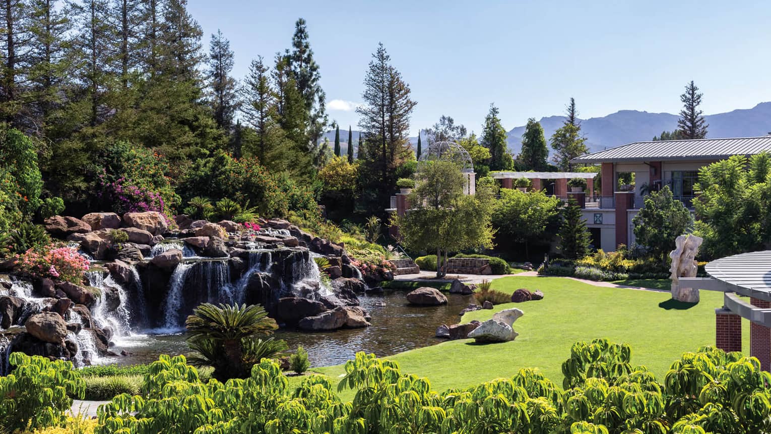 Waterfalls over rocks, boulders in garden at Four Seasons Hotel Westlake Village