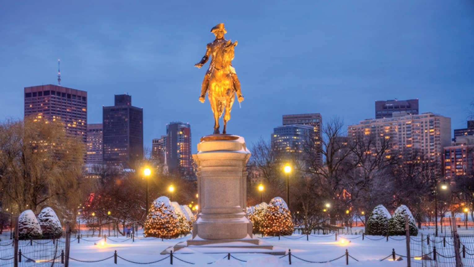 A snowy military monument in a park in boston