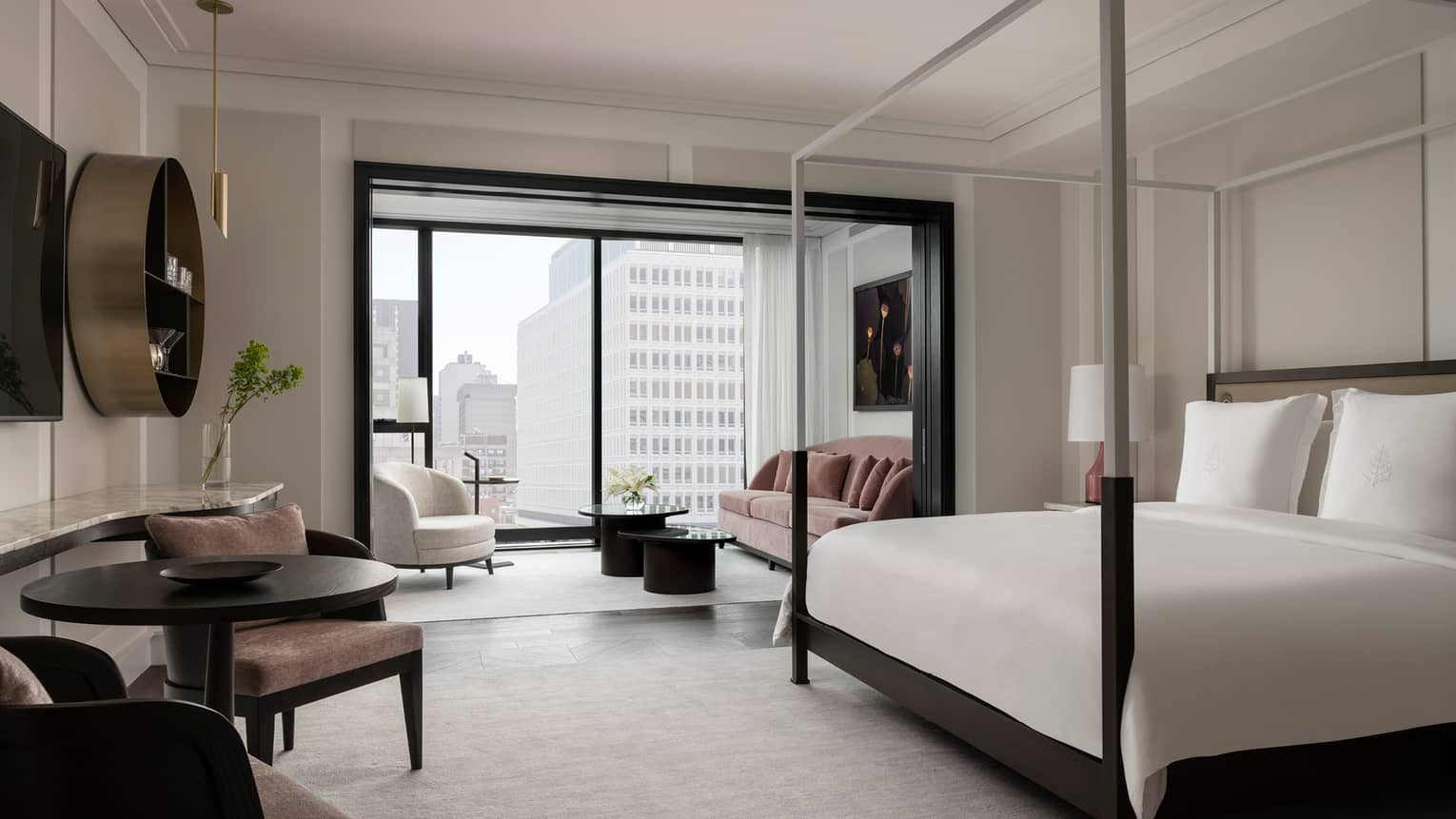 Chic, modern guest room with neutral decor and black trim, floor-to-ceiling window