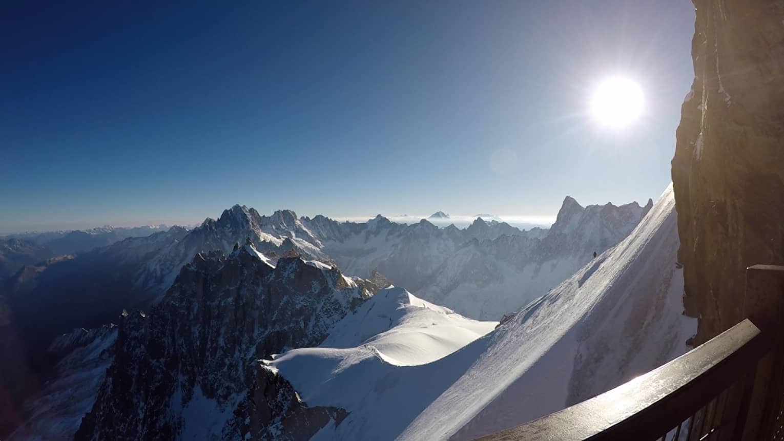 Snowy peaks of the French Alps with hazy sunshine in backdrop