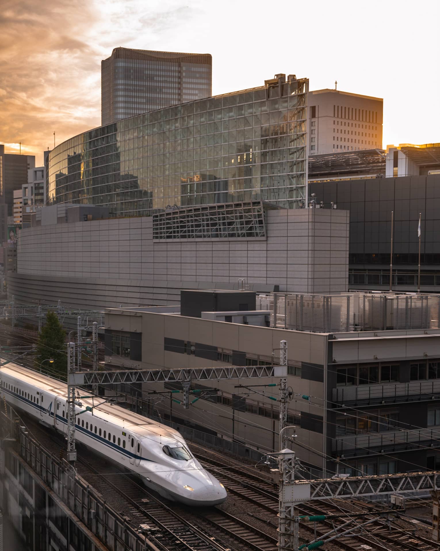 Shinkansen bullet train arrives at the station at sunset