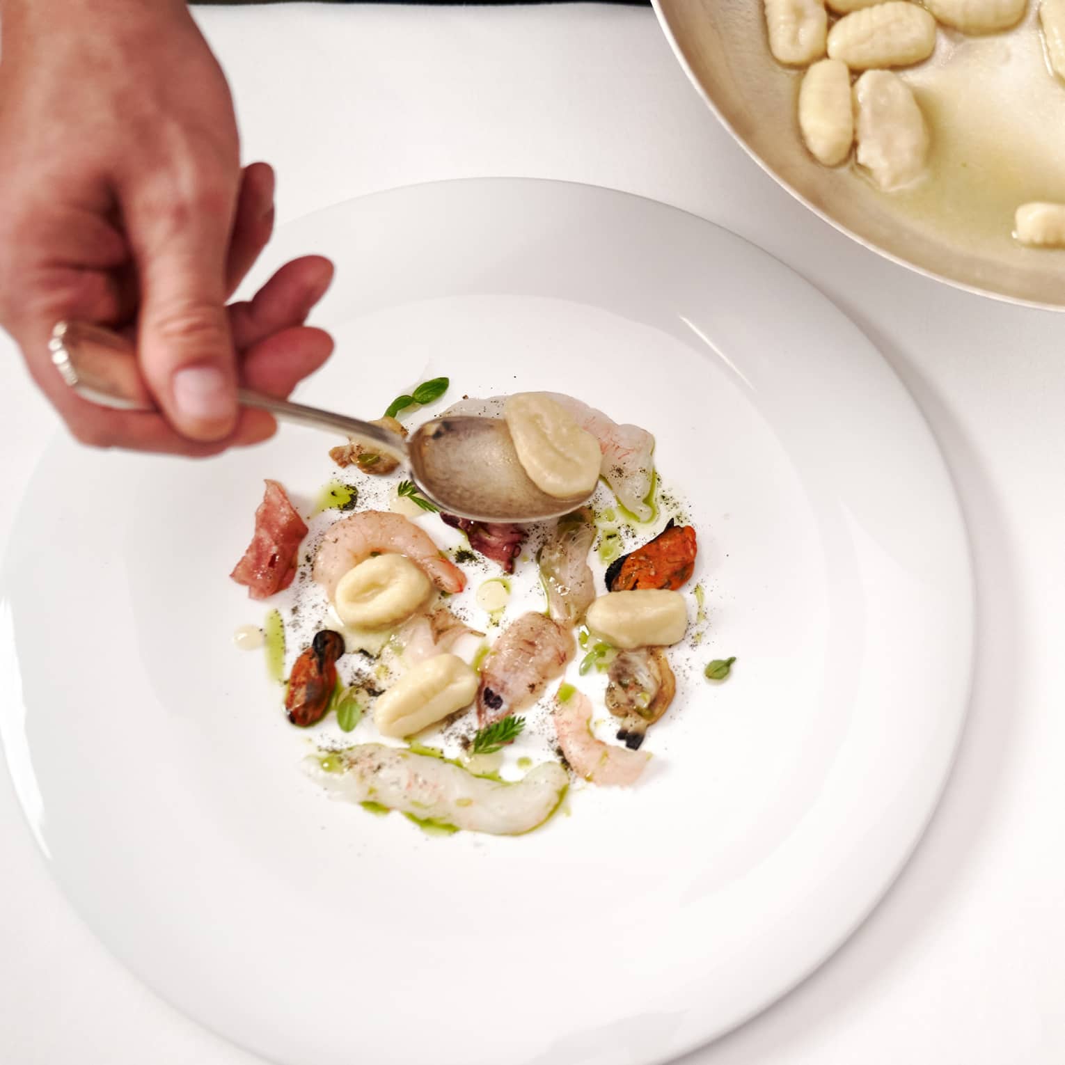 Gnocchi with raw seafood.