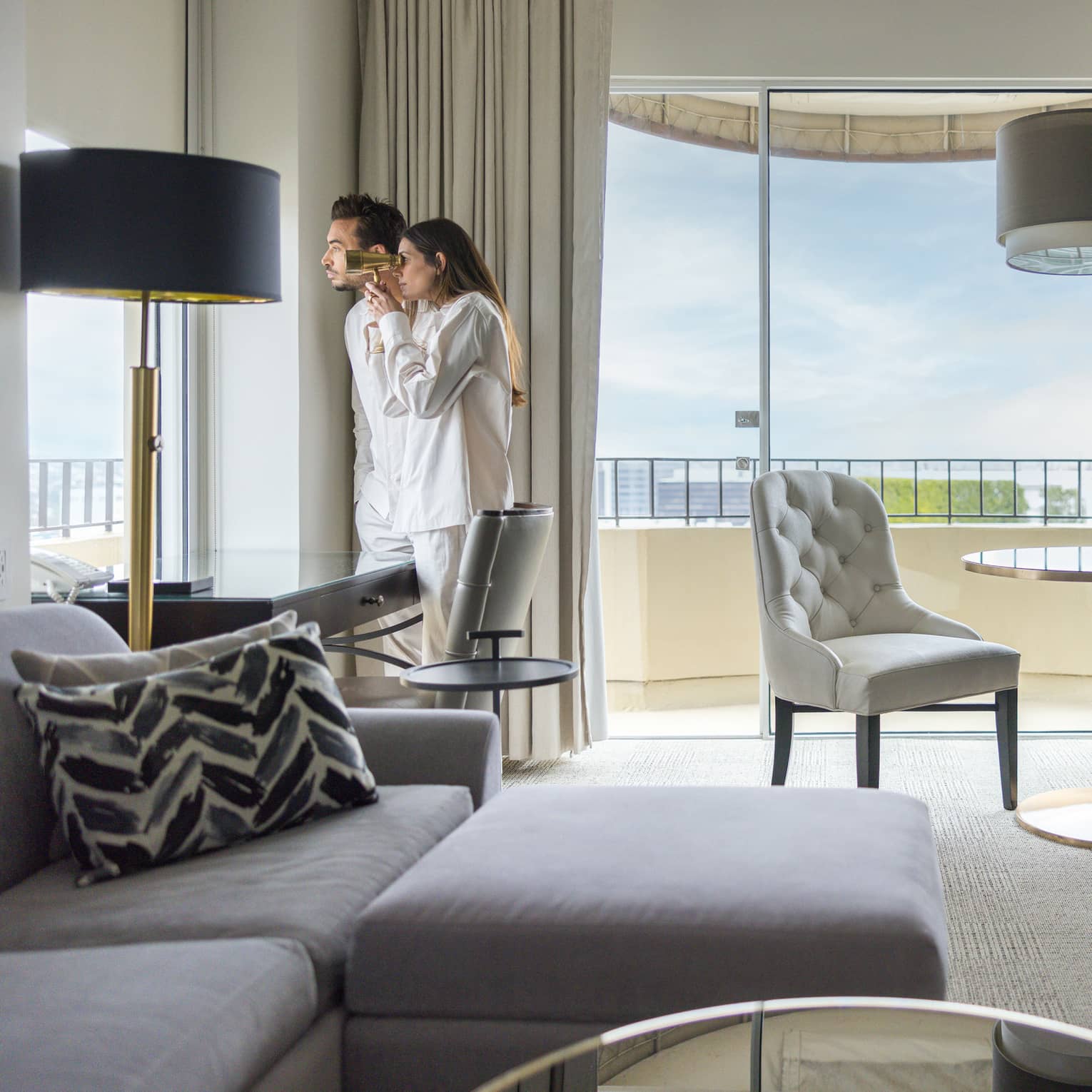 Two guests looking out of the window of their guest room