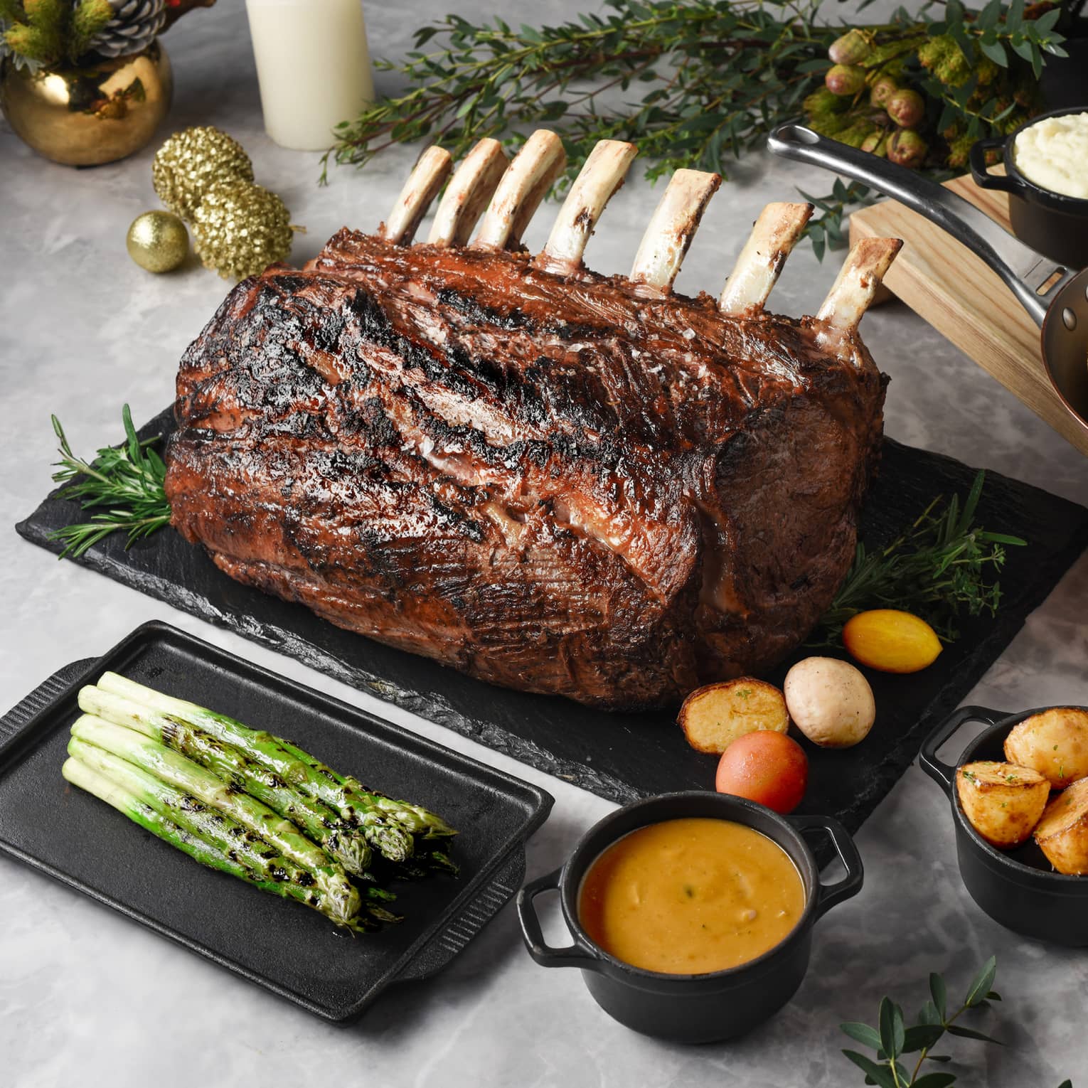 Holiday spread with salt-crusted prime rib, roasted potatoes, charred asparagus and lemon tart