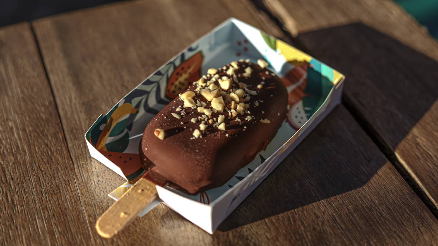 Chocolate-covered ice cream on a stick with peanut crumbles on top