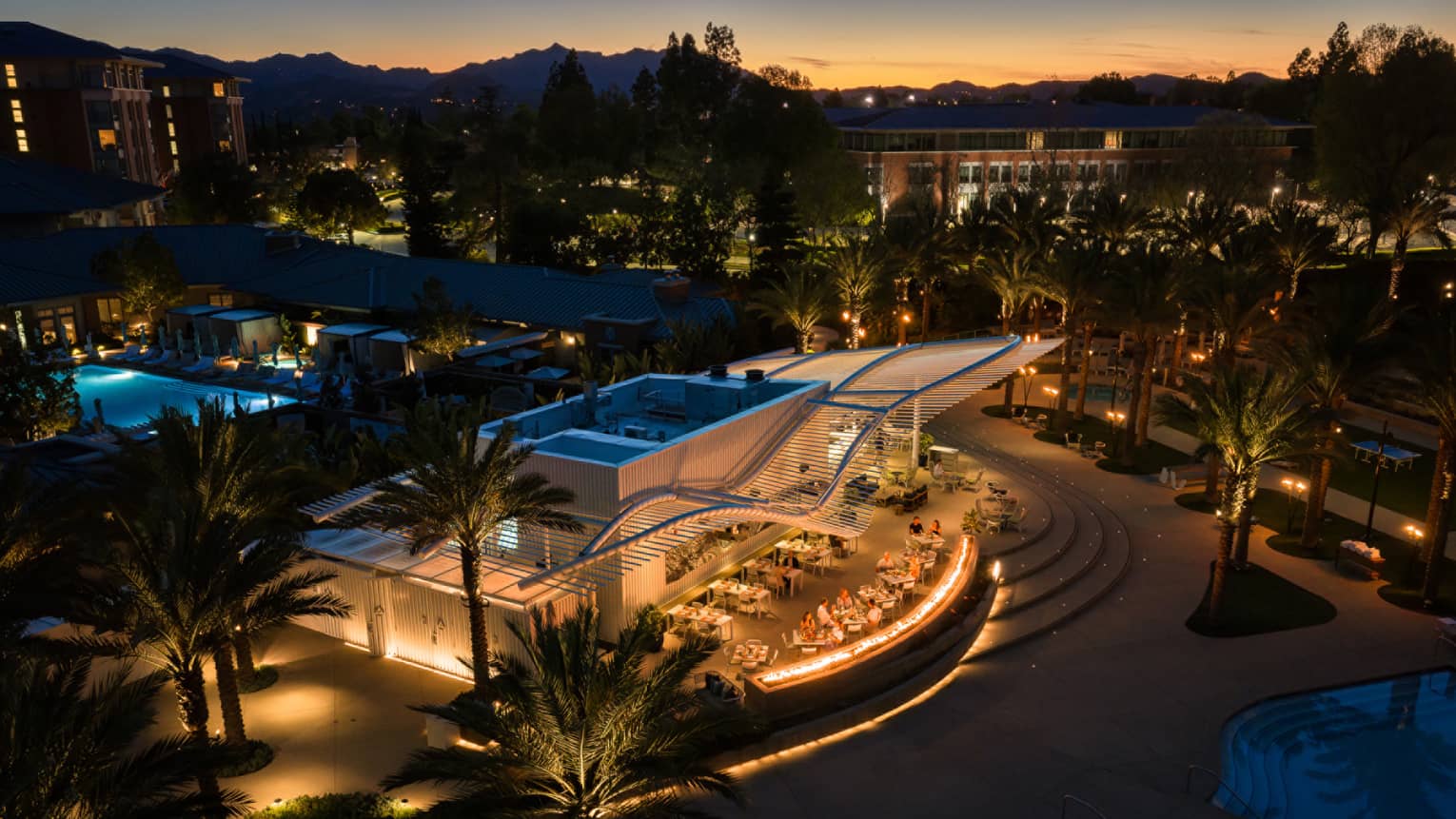 Aerial view of outdoor poolside restaurant at night